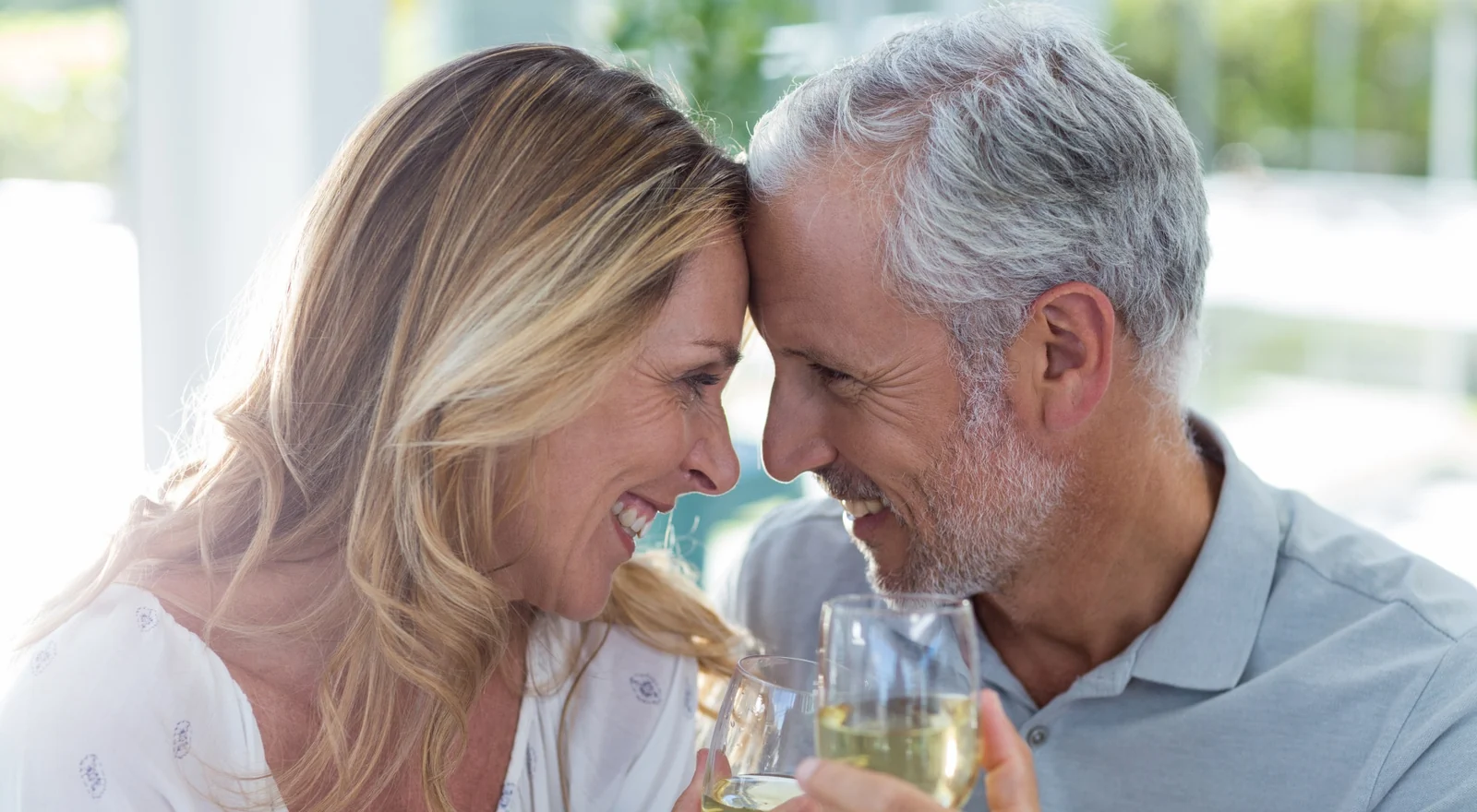 A mature couple sharing a relaxed moment over drinks